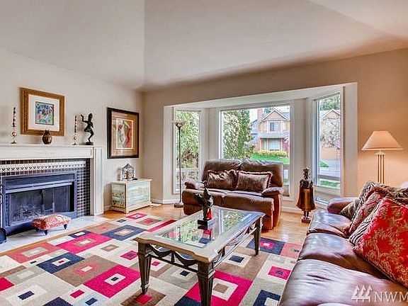 Elegant living room with bay window and cozy fireplace.