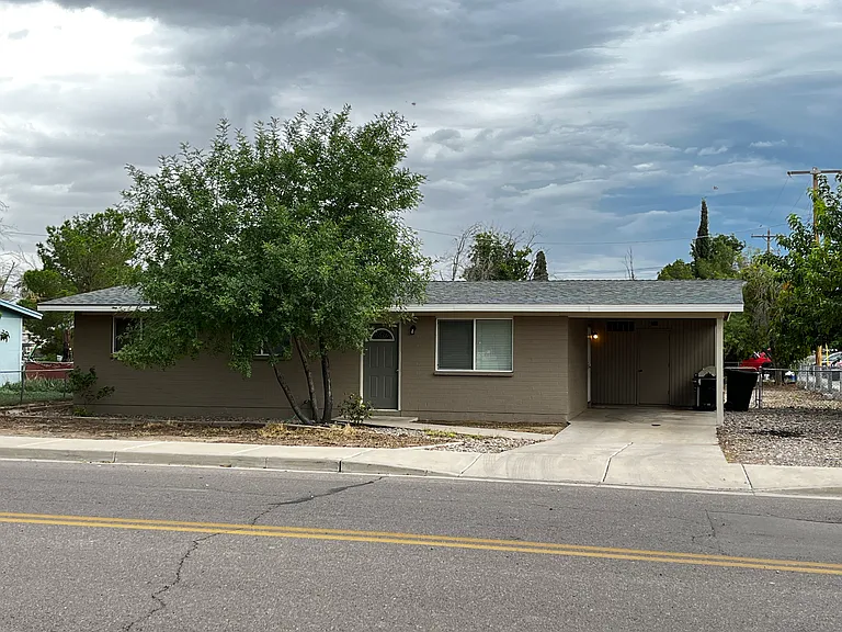 Front exterior of house with covered parking area