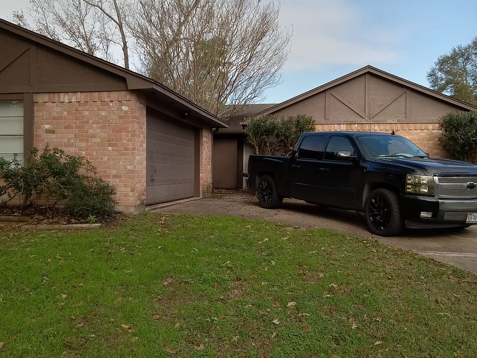 Front view with long driveway and double car garage