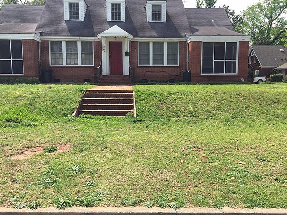 TRI-PLEX BRICK HOME RED DOOR IS ENTRANCE TO UPSTAIRS