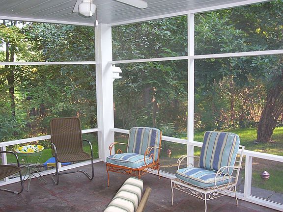 The lovey screen porch over looks the stone patio