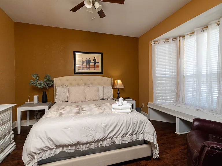 Cozy and inviting bedroom featuring a tufted headboard and warm, earthy tones.