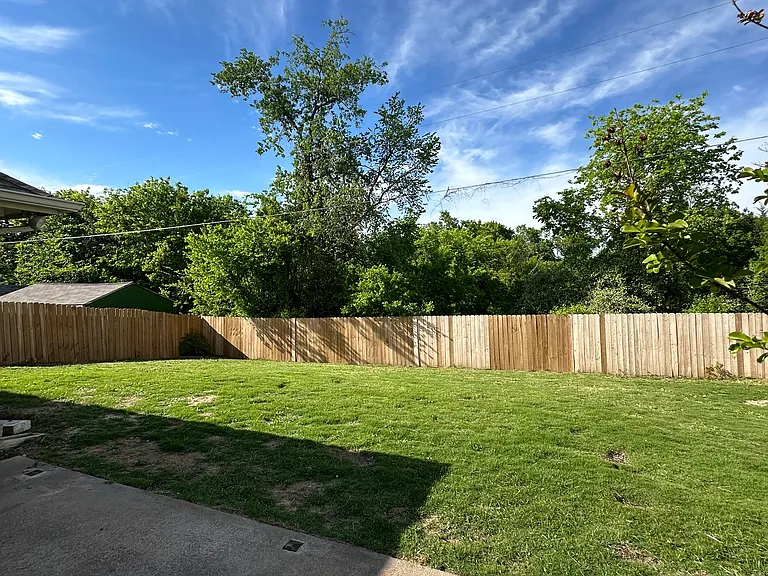 Fully fenced backyard with shed