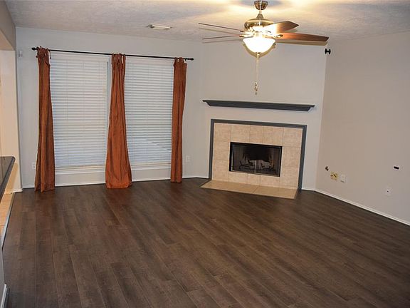 A corner fireplace waits to warm the hearts of all that gather here!