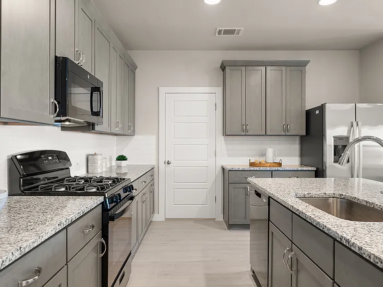 Large kitchen with excellent storage and countertop work space.