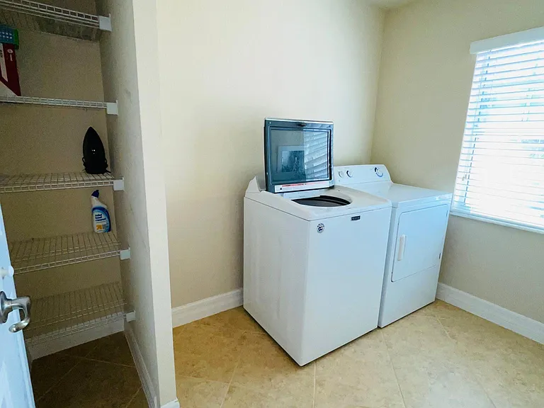 Laundry room with closet
