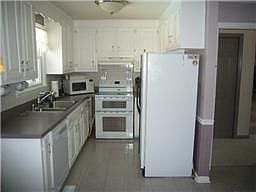 Corian tops in kitchen additional cabinets not pictured, large kitchen sink