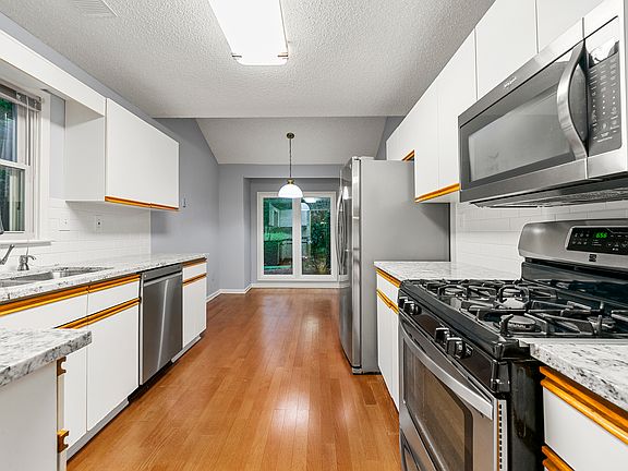 Kitchen - new granite countertops and original well-maintained cabinets. Updated dishwasher, microwave, and the fridge. Hardwood floors.