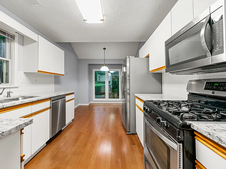 Kitchen - new granite countertops and original well-maintained cabinets. Updated dishwasher, microwave, and the fridge. Hardwood floors.