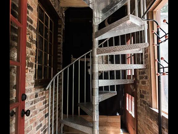 Spiral staircase leading up to the apartment. For move-in purposes, there is a fire escape with more traditional stairs that could be used.