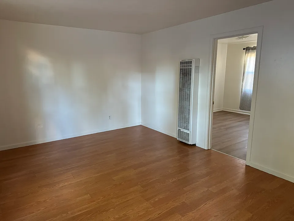 Living room has an efficient gas heater. Bedroom is off the living room. A short hallway with a pantry closet on the other side of the living room leads to the kitchen