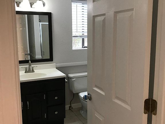 Bathroom with shower, fan and window that opens