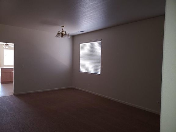 This picture seems a little dark but I think it was my camera. Front Living Room with an area for your dining room table. This is near the front of the house by the front door and 4th bedroom at the front of the house.