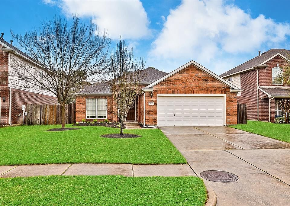 One story convenience with a two-story home on each side. Open space behind the house. Deep, covered entrance to front door.