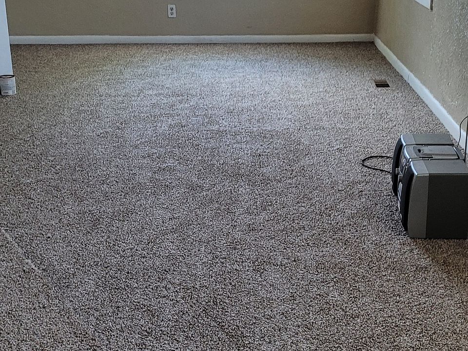 large living room with ceiling fans. New carpet installed