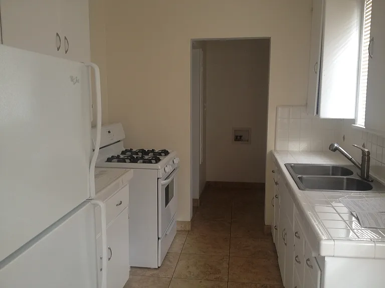 Kitchen to service porch with washer / dryer