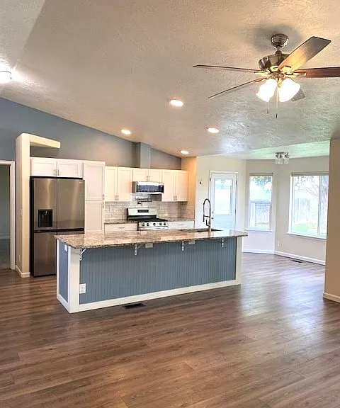 Kitchen view of dining and part of living area