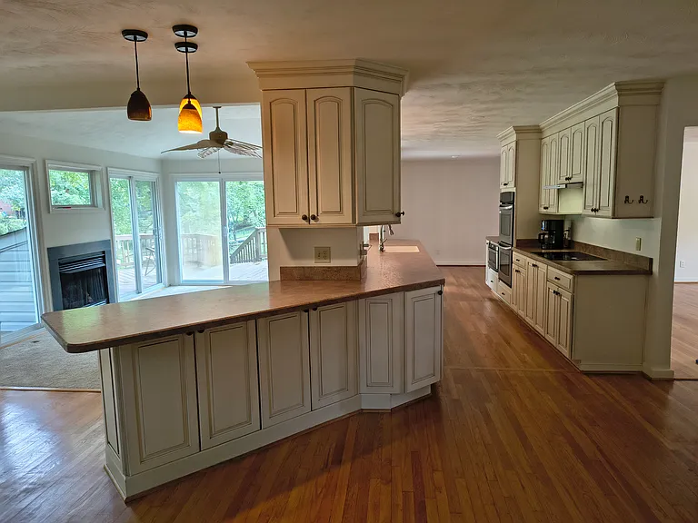 Open kitchen overlooks the living room and waterfront backyard views.