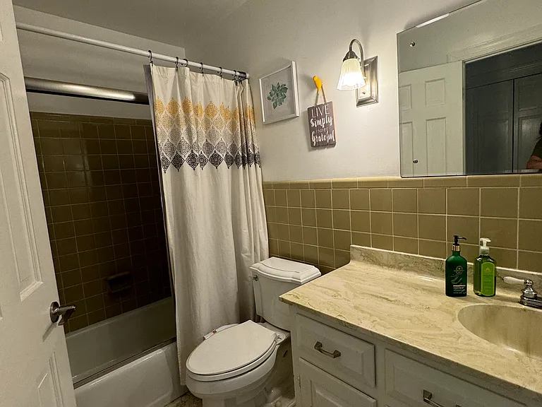 Downstairs Left shared bathroom with shower and tub