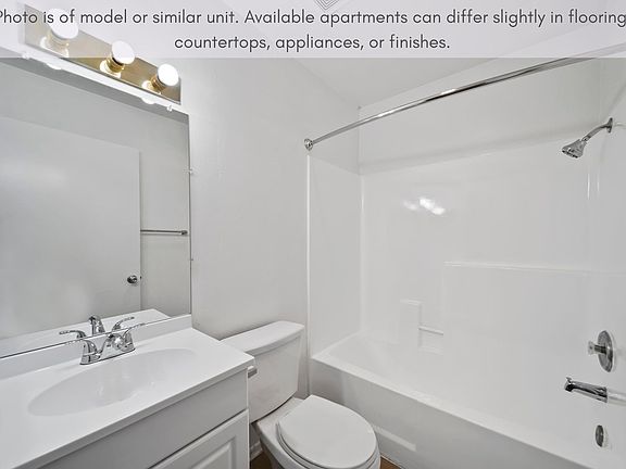 Bright bathroom with a full tub and generous counter space for everyday use.