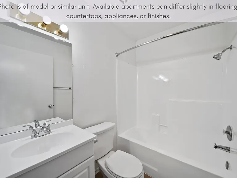Bright bathroom with a full tub and generous counter space for everyday use.