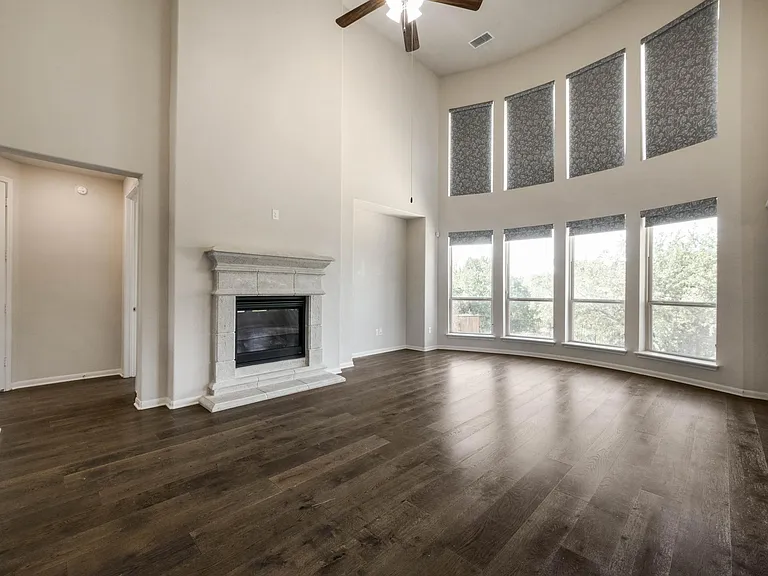 Living room with ceiling to floor windows with motorized shades