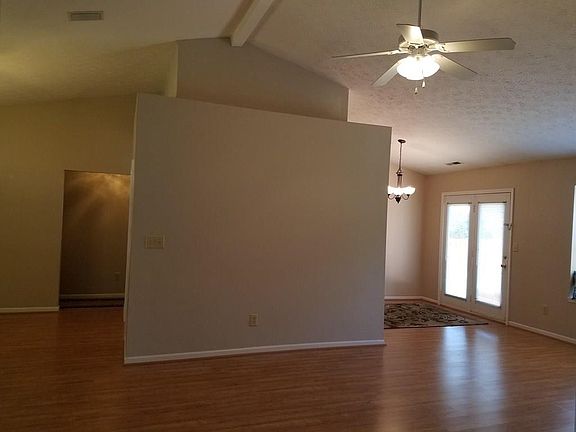 Great Room Looking into breakfast room to the right, dining room to the left (which has also been used as an office area in the past) and kitchen behind the wall. The vaulted ceiling and plant ledge add character.