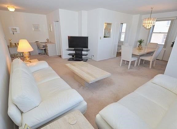 Bight and airy living room has sunny Eastern exposures.  The room has a door leading to a private balcony, great for enjoying the outdoors, and covered parquet floors.  The living room also open to a large entry foyer.  The living room is 20'-0" x 12'-0",