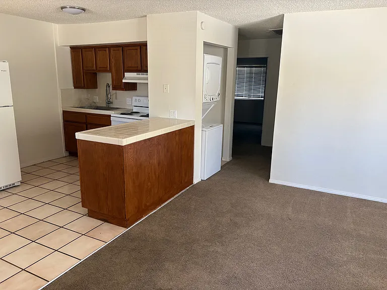 Kitchen and stack washer/dryer from living room
