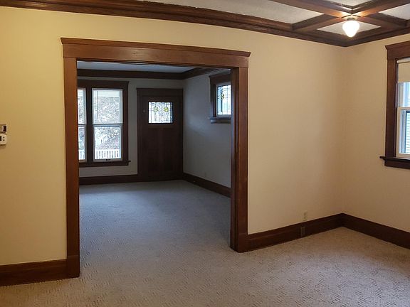 Dining Room: Carpeted; Wood beam ceiling with multiple light fixtures.