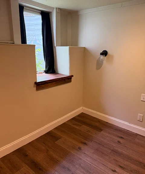Egress window, bedside sconce with switch, reclaimed wood window sill