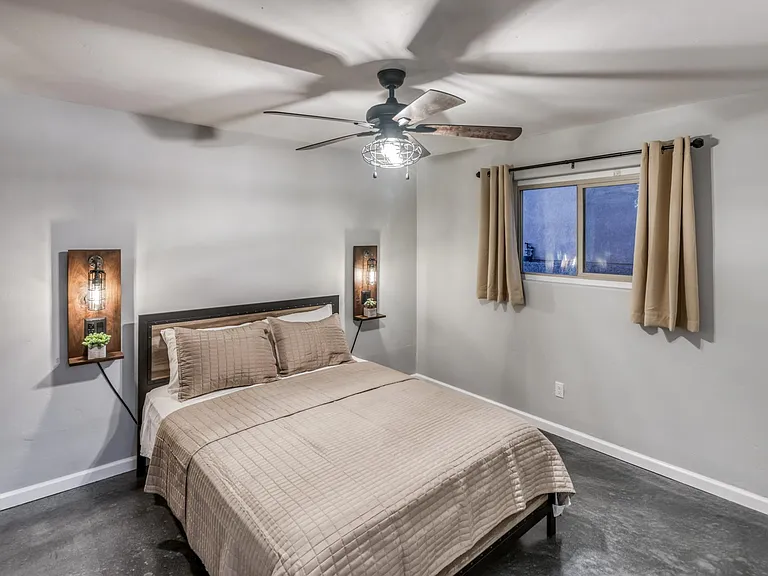 Guest bedroom offering clean lines, neutral finishes, and ample wall space for full furniture layout.
