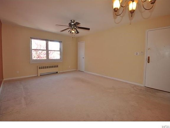 Bright large living room with wall to wall carpet and large walk-in closet.