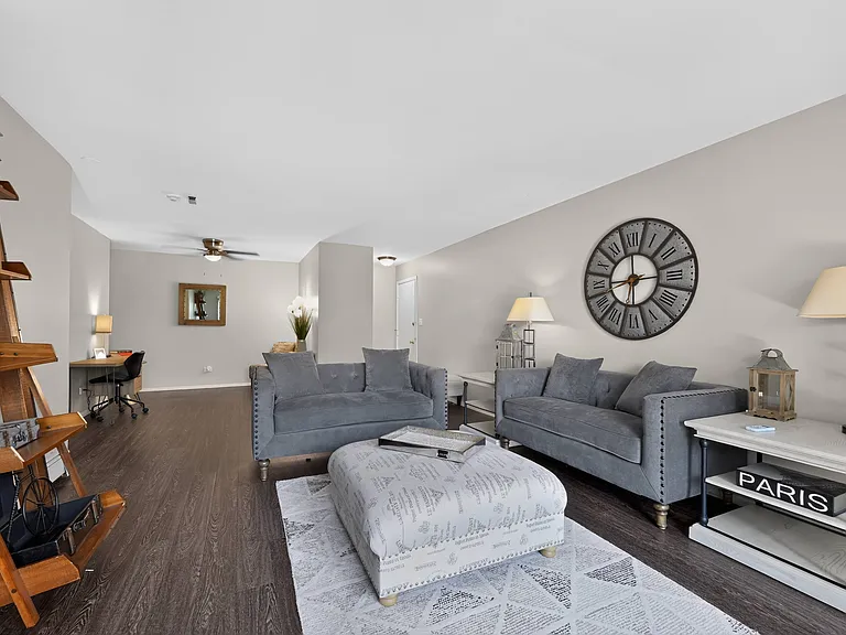 Settle into a stylish living room featuring a grey couch and a charming layout at Renaissance at Carol Stream in Carol Stream, IL.
