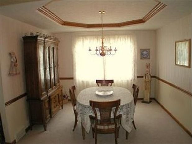 Formal dining room w/ crowned tray ceiling.