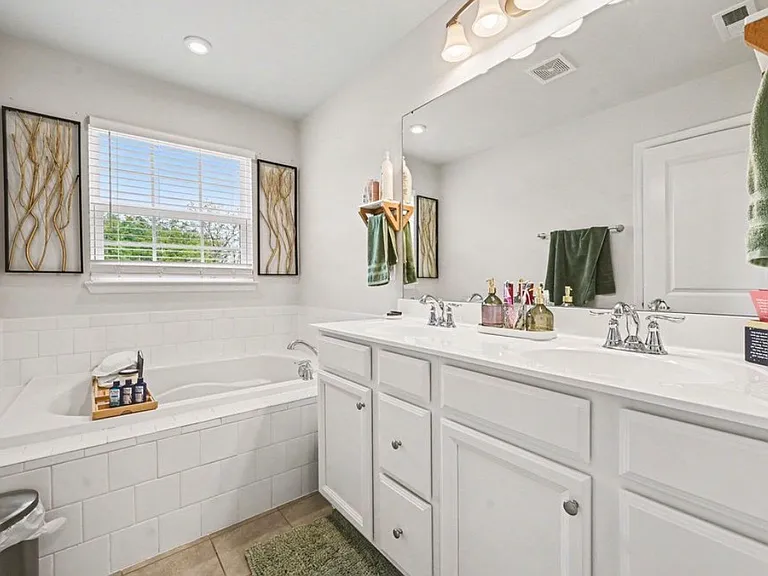 Beautifully done master bathroom with walk in shower and large tub