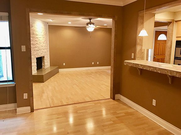 Open floorplan flows from dining to living to kitchen