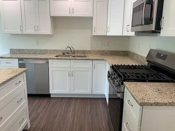 Granite counter tops, new appliances, white cabinets and vinyl plank flooring.