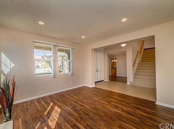 Living room with recessed lighting, new laminate flooring