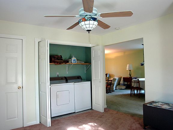 Stairs to upstairs behind door on left. Photo taken in dining area or work room.