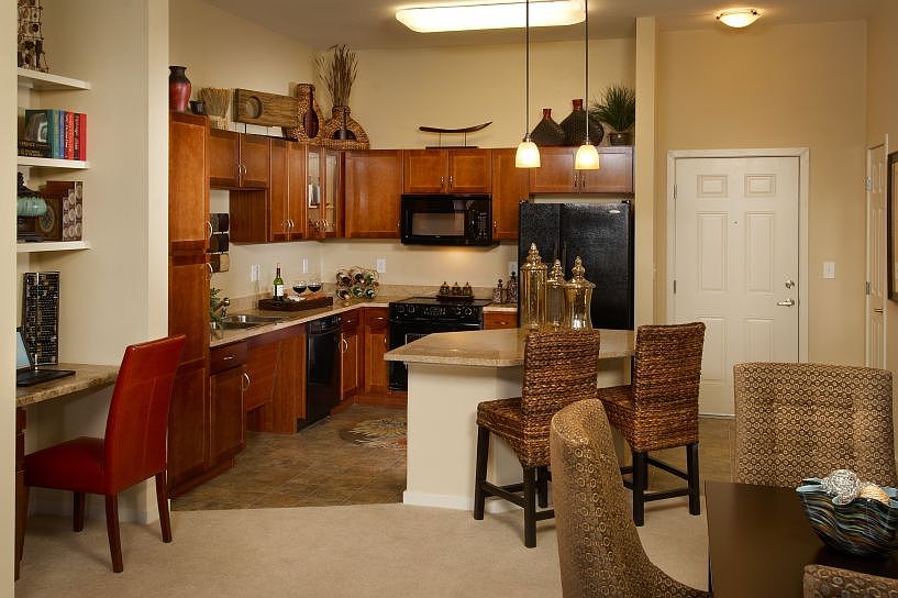 Kitchen with granite countertops and black appliances
