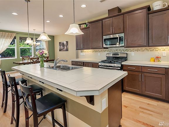 Kitchen with large eating bar.