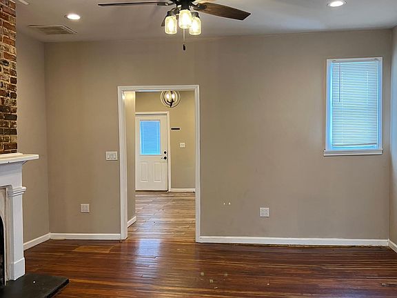 Living room. Kitchen and back door beyond.