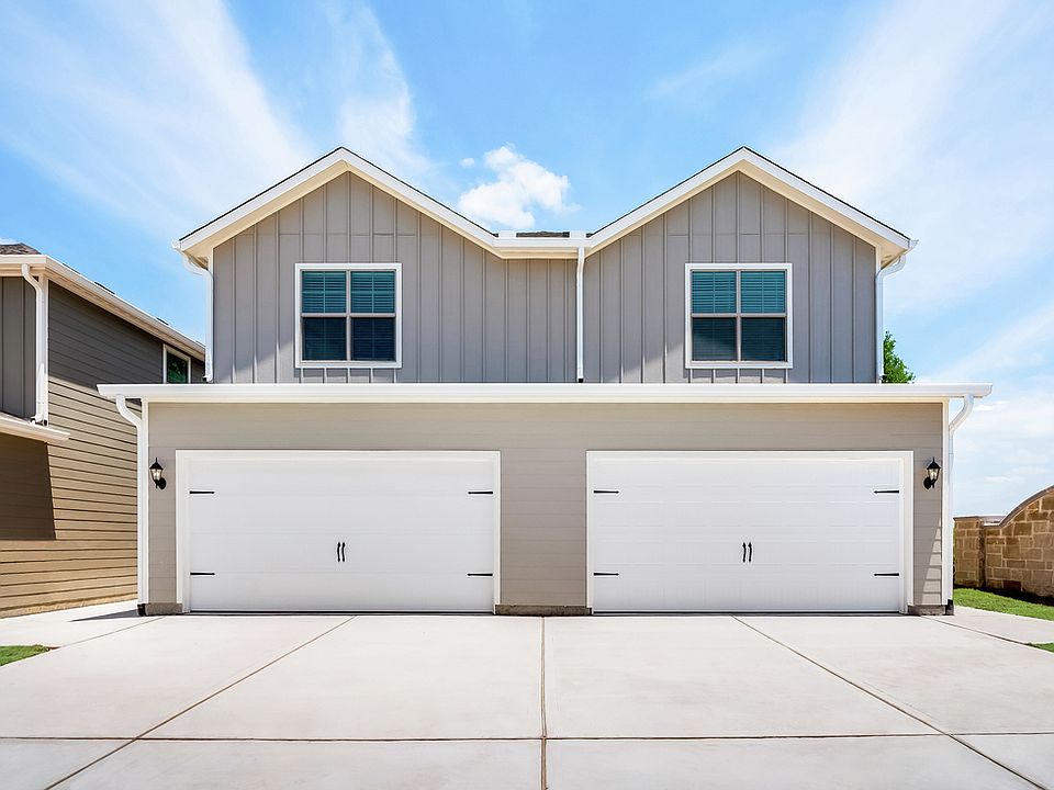 Two-story townhomes, each with their own two-car garage and driveway