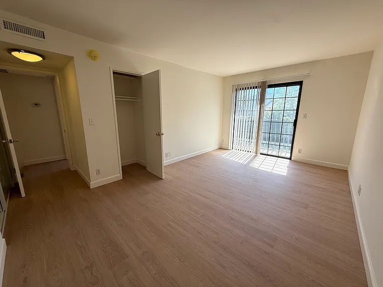 Second Bedroom with new vinyl wood floors with balcony