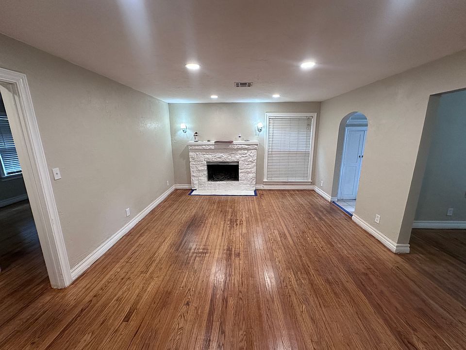 Living Room. Front door is through the curved archway to the right. Dining room is through the square walkway to the right. Bedrooms through the square walkway to the left.