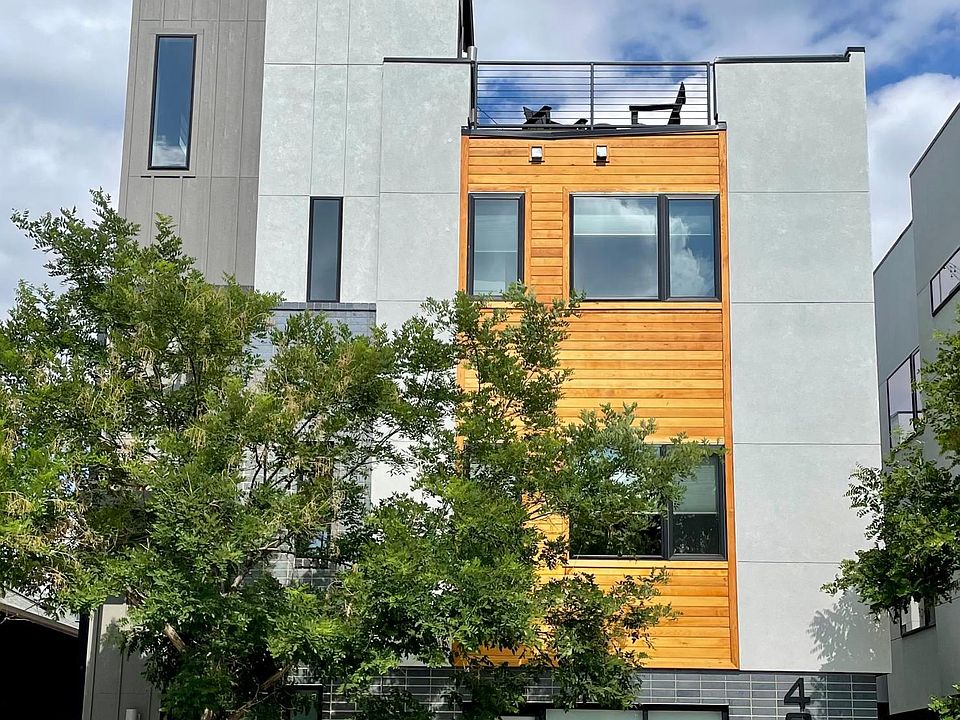 Front of building from street. Front door to unit accessed via the path to the left of tree.