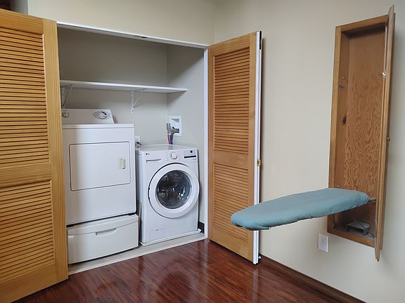 Washer, dryer, storage drawer and hidden ironing board.