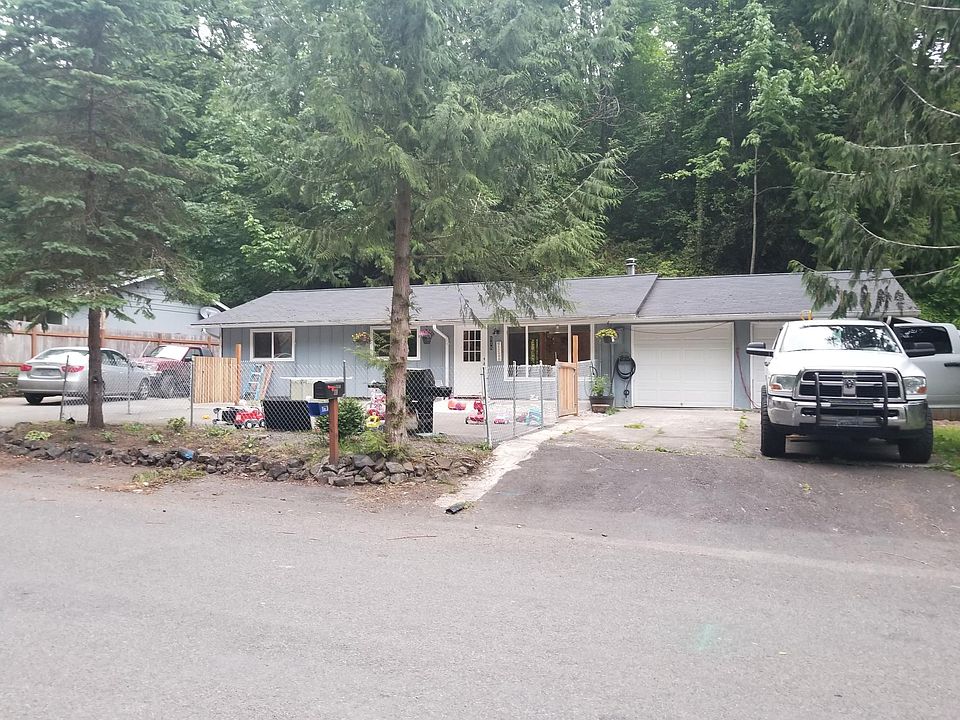 Front of house, fenced front area, cement ramp to the front door, French drain around the house to the street, two car garage, off street parking.