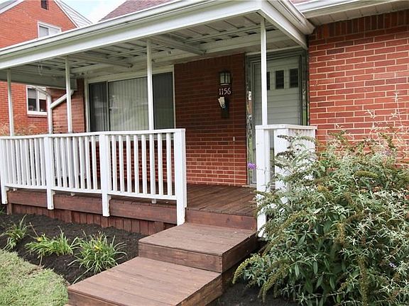 Covered front porch to relax on and enjoy the manicured landscape.